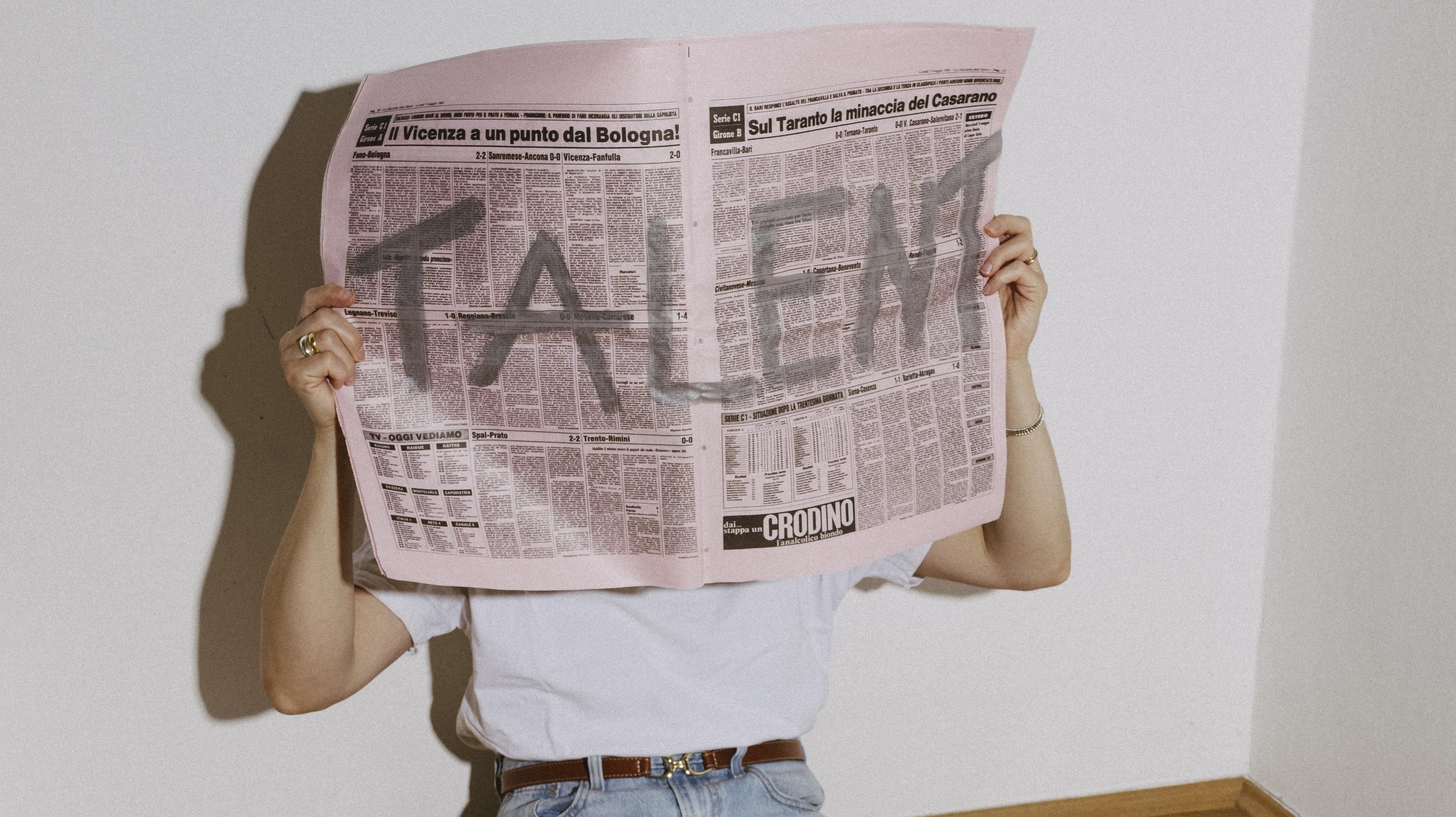 Gerhild holding a newspaper with TALENT written on it
